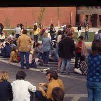 Students sit across Stadium Way