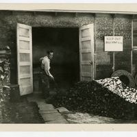 Man shoveling coal at Minidoka Relocation Center.